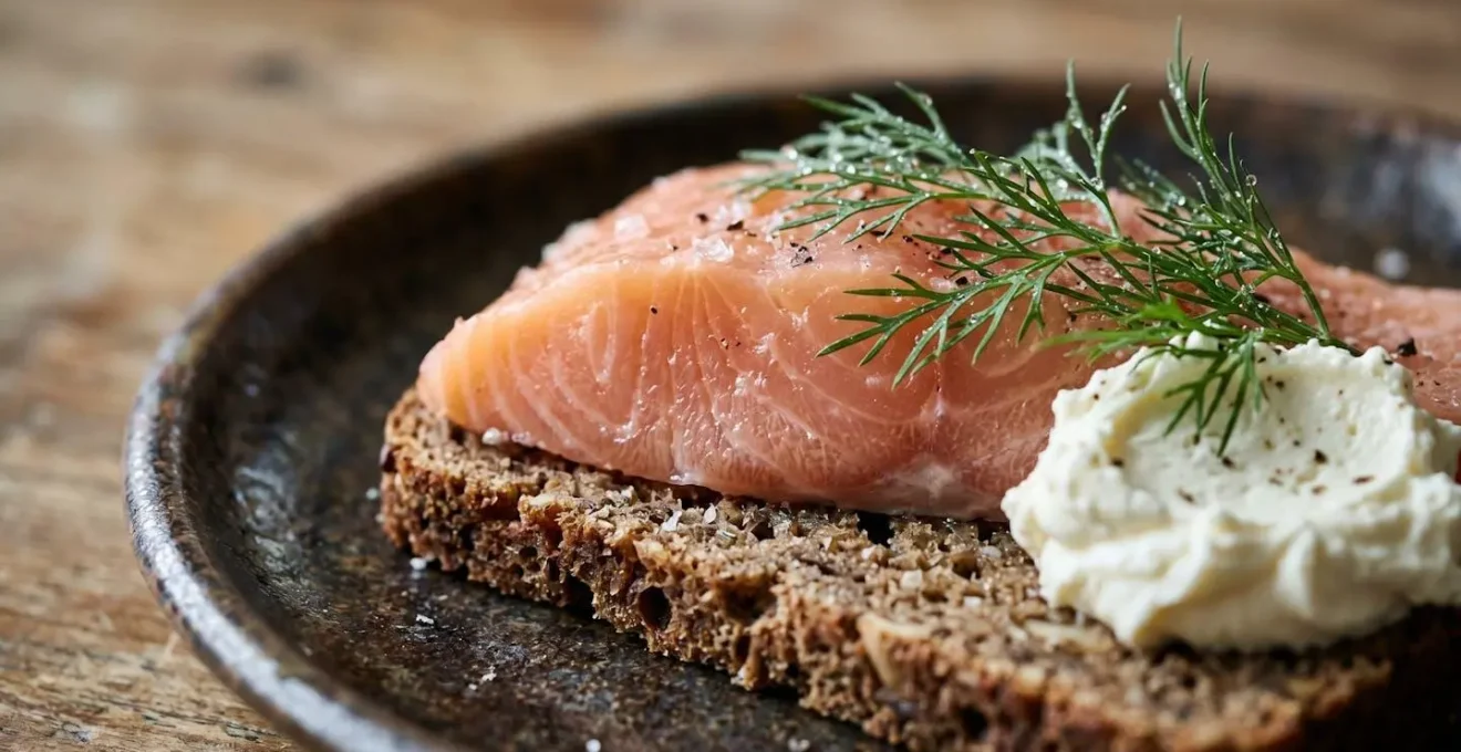Extreme close-up of traditional Danish open-faced sandwich showing textures of rye bread and fresh toppings