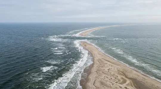 Dramatic aerial view of Grenen sandbar where Skagerrak and Kattegat seas collide at Denmark's northernmost tip