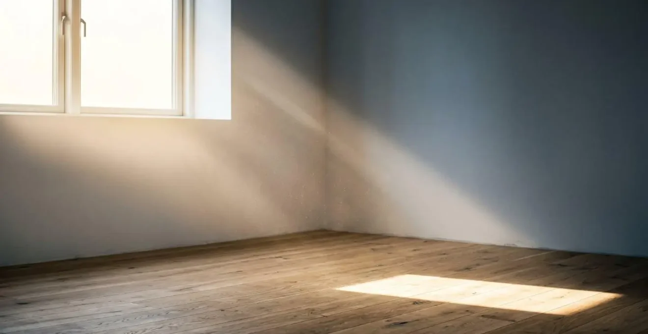 Soft morning sunlight streaming through Danish window onto empty minimalist interior surface creating natural shadow patterns